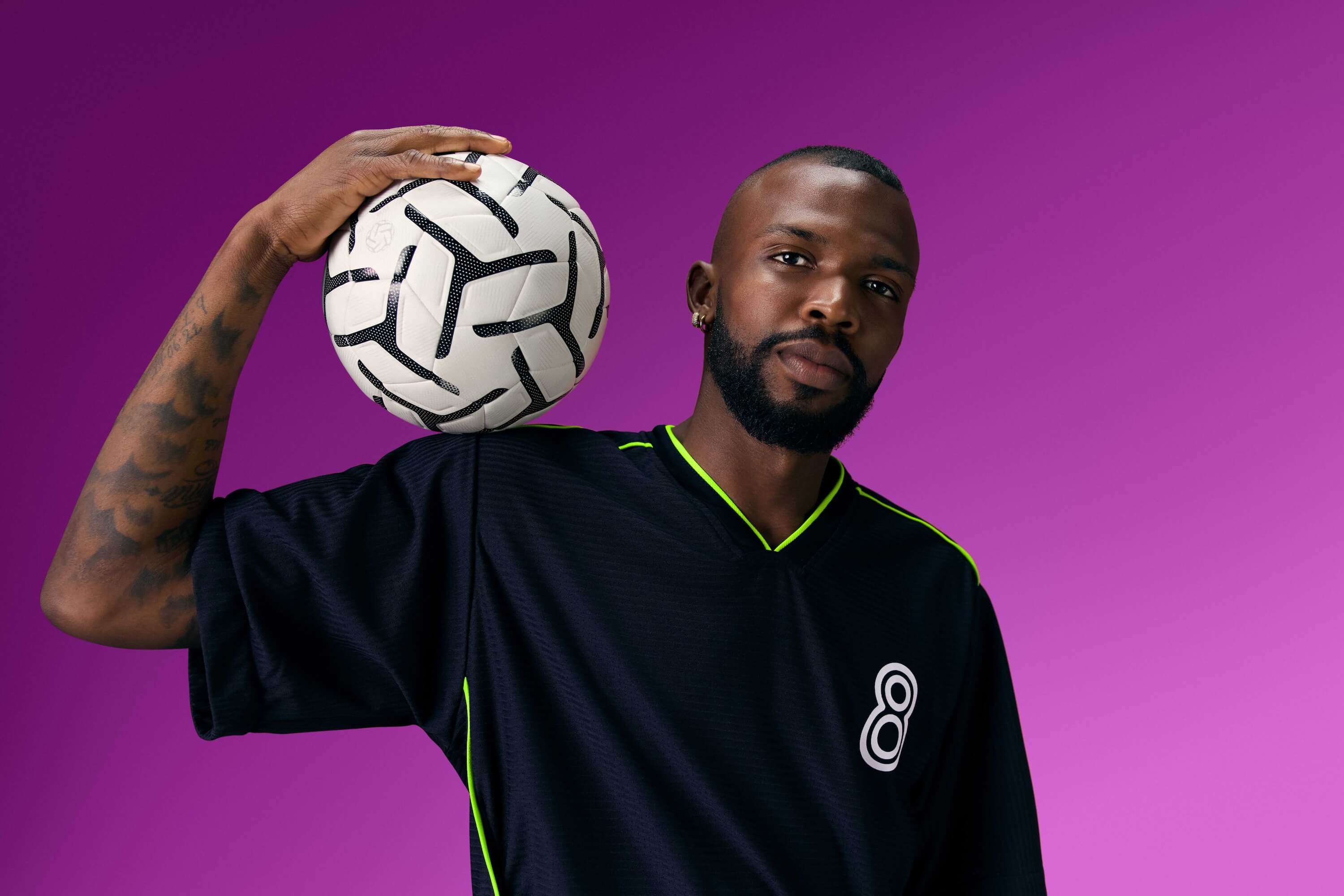 Athlete holding a football, representing the energy of the BMS presence at the NYNJ World Cup 26 Jersey Fan Hub during the World Cup